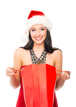Young and beautiful Christmas shopper girl isolated on white backgroundの写真素材