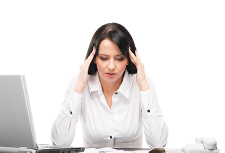 Young and attractive business woman working in office isolated on whiteの写真素材