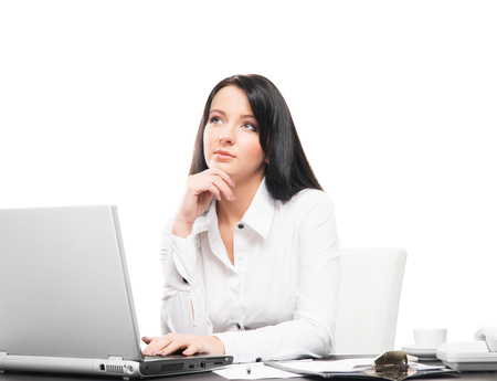 Young and attractive business woman working in office isolated on whiteの写真素材