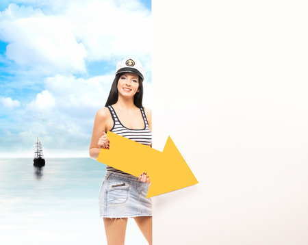 Young, beautiful and sexy sailor girl over sea and sky backgroundの写真素材