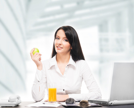 Business woman has a vegetarian lunch in officeの写真素材