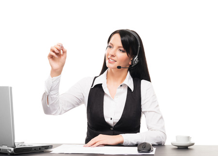 Young, confident and beautiful customer support operator working in a call centerの写真素材