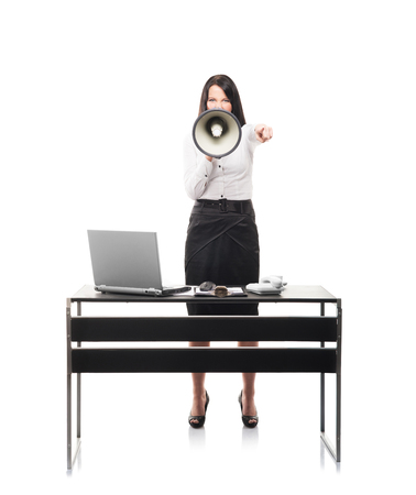 Angry and furious business woman screaming isolated on whiteの写真素材