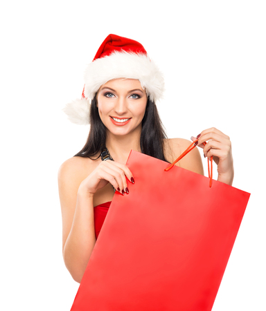 Young and beautiful Christmas shopper girl isolated on white backgroundの写真素材
