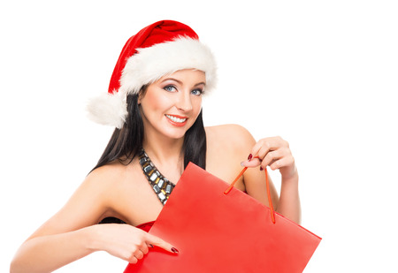 Young and beautiful Christmas shopper girl isolated on white backgroundの写真素材