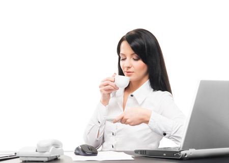 Young and attractive business woman working in office isolated on whiteの写真素材