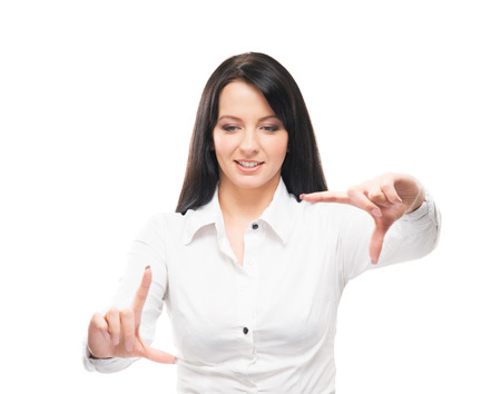 Young and attractive business woman working in office isolated on whiteの写真素材