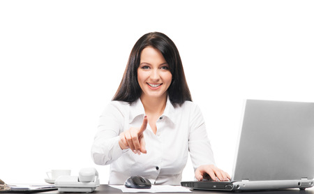 Young and attractive business woman working in office isolated on whiteの写真素材