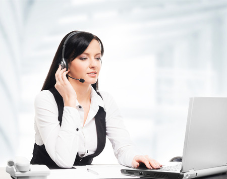 Customer support operator working in a call center officeの写真素材