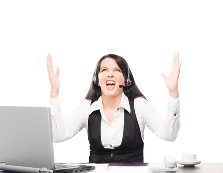 Young, confident and beautiful customer support operator working in a call centerの写真素材