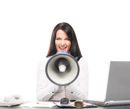 Angry and furious business woman screaming isolated on whiteの写真素材