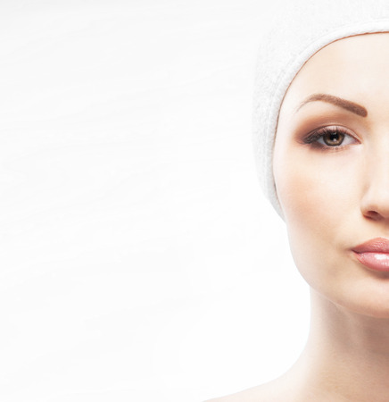 Spa styled portrait of young and beautiful woman isolated on whiteの写真素材