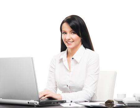Young and attractive business woman working in office isolated on whiteの写真素材