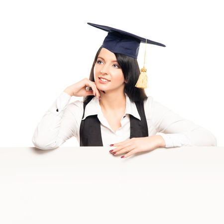 Young, beautiful and happy graduate girl with a blank banner isolated on whiteの写真素材