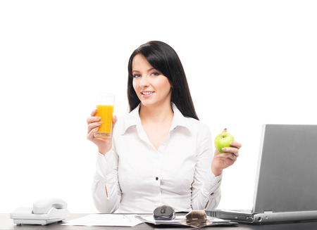 Business woman has a vegetarian lunch in office isolated on whiteの写真素材