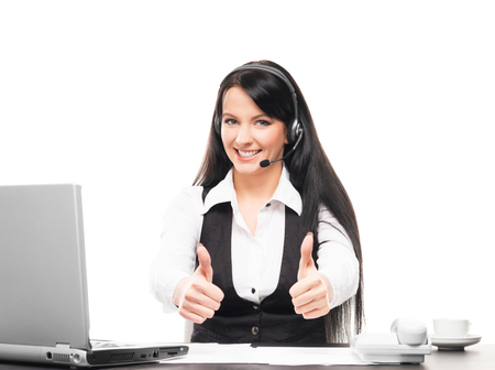 Young, confident and beautiful customer support operator working in a call centerの写真素材