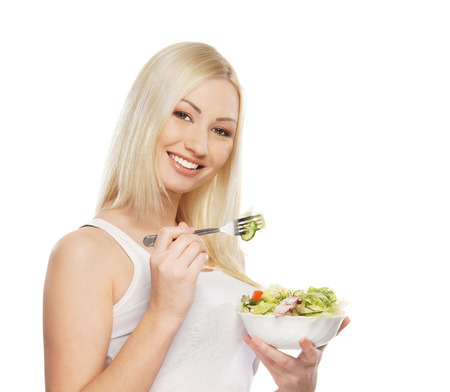 Young attractive girl with fresh and tasty saladの写真素材