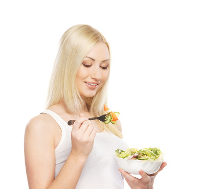 Young attractive girl with fresh and tasty saladの写真素材