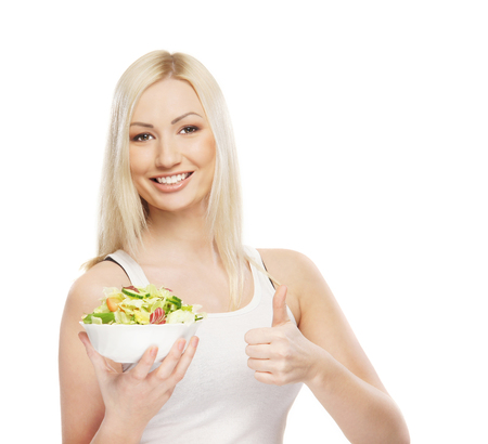 Young attractive girl with fresh and tasty saladの写真素材