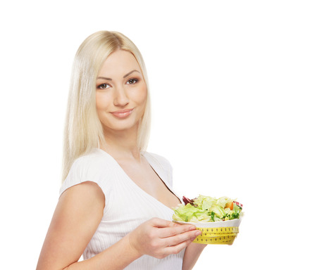Young attractive girl with fresh and tasty saladの写真素材