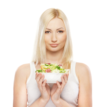 Young attractive girl with fresh and tasty saladの写真素材