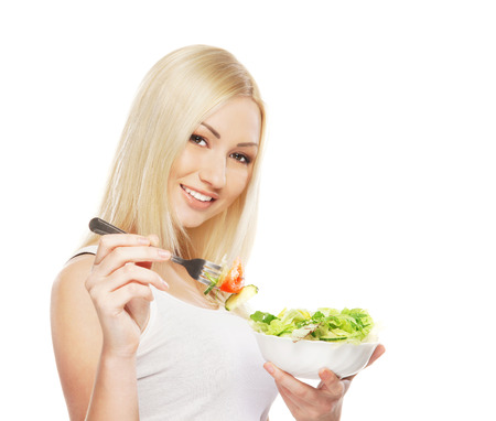 Young attractive girl with fresh and tasty saladの写真素材