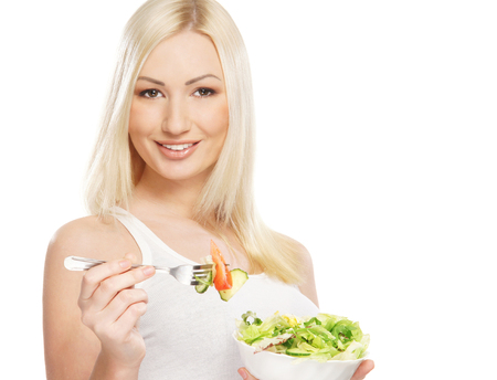 Young attractive girl with fresh and tasty saladの写真素材