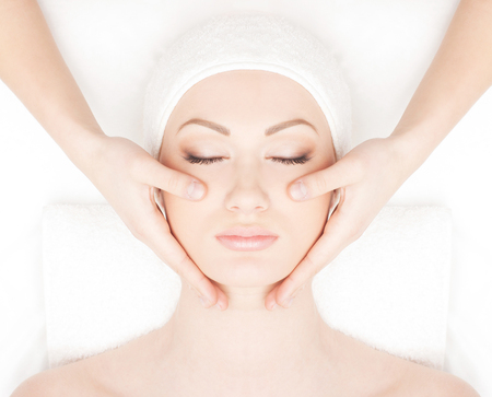 Spa styled portrait of young and beautiful woman isolated on whiteの写真素材