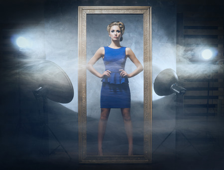 Young and emotional woman in fashion dress over glamour background (photo studio backstage)の写真素材