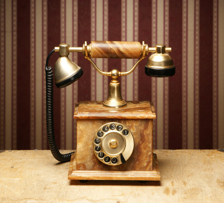 Vintage telephone over retro backgroundの写真素材