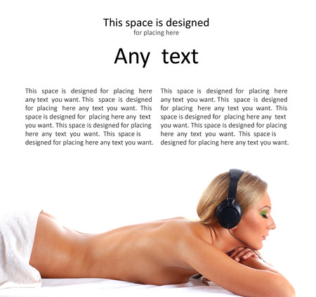 Young beautiful sexy lady getting spa treatment and listening to the music isolated on whiteの写真素材