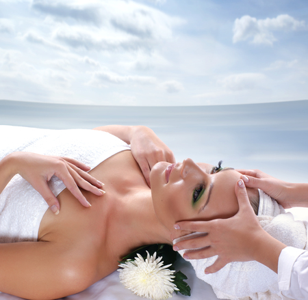 Beautiful woman getting spa treatment near the oceanの写真素材