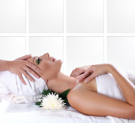Young beautiful lady getting spa treatment isolated on whiteの写真素材