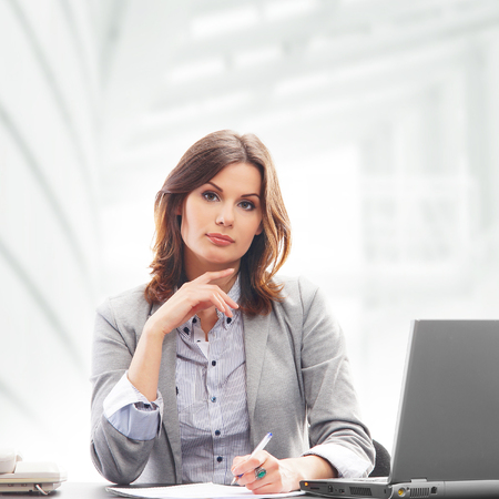 Business woman in office isolated on whiteの写真素材