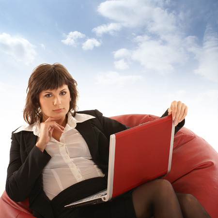Attractive businesswoman with notebook isolated on whiteの写真素材