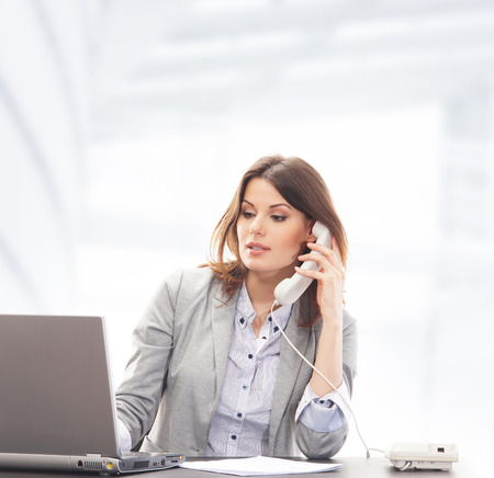 Business woman in office isolated on whiteの写真素材