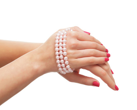 Beautiful female hands with the pearl chaplet isolated on whiteの写真素材