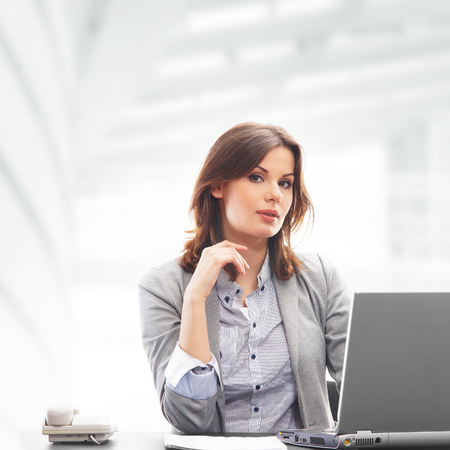 Business woman in office isolated on whiteの写真素材