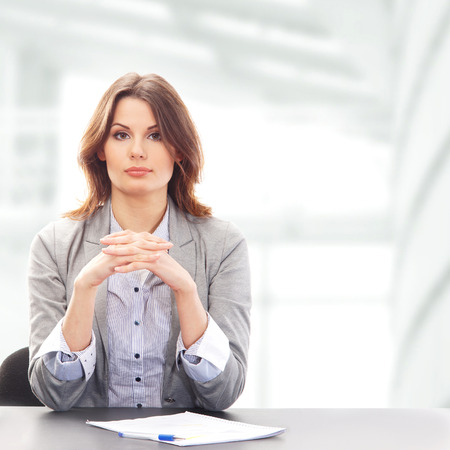 Business woman in office isolated on whiteの写真素材