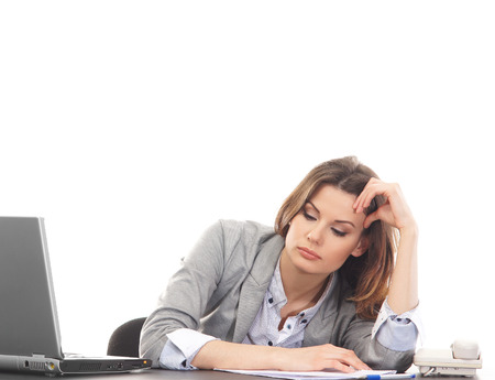 Sad business woman in office isolated on whiteの写真素材