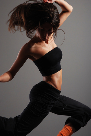 Young and sexy modern dancer over grey backgroundの写真素材