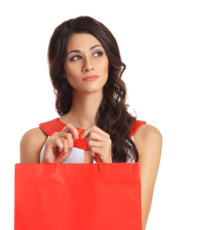 Young beautiful woman with some shopping bags isolated on whiteの写真素材