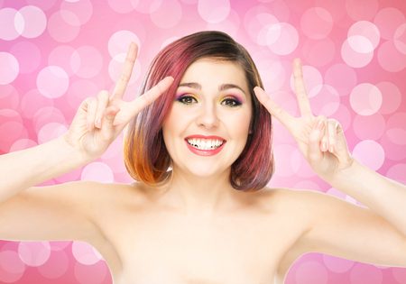 Beautiful smiling girl with colorful make-up on bubble background.の写真素材