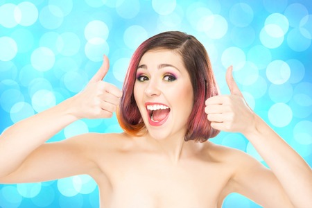Beautiful smiling girl with colorful make-up on bubble background.の写真素材