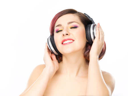 Beautiful girl listening to the music throughout headphones.の写真素材
