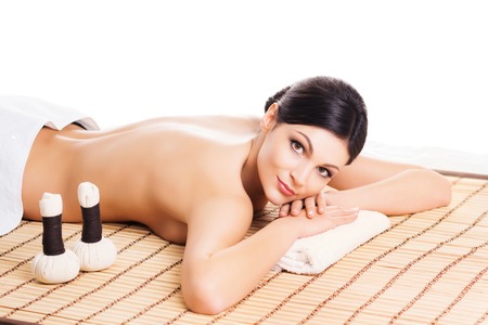 Beautiful, young and healthy woman in spa salon. Isolated on white. Spa, health and healing concept.の写真素材