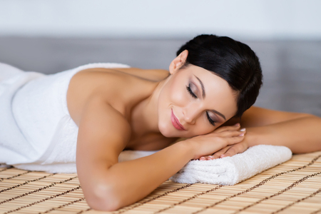 Beautiful, young and healthy woman in spa salon. Spa, health and healing concept.の写真素材