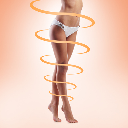 Close-up of thin and beautiful female body. Weight loss, sports, exercising, tan, sun burn concept.の写真素材