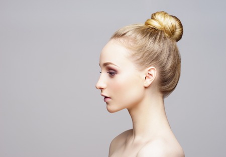 Beauty close-up portrait of beautiful, fresh and healthy girl over grey background.の写真素材