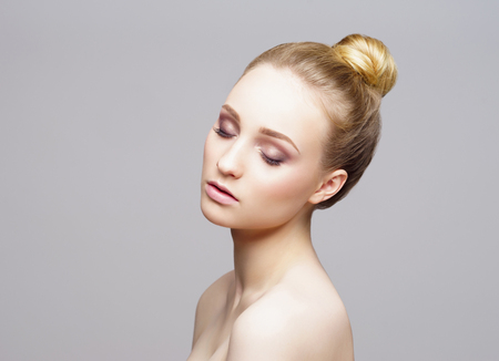 Beauty close-up portrait of beautiful, fresh and healthy girl over grey background.の写真素材